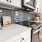 kitchen area on wooden floor with spacious counter-space and designer appliances
